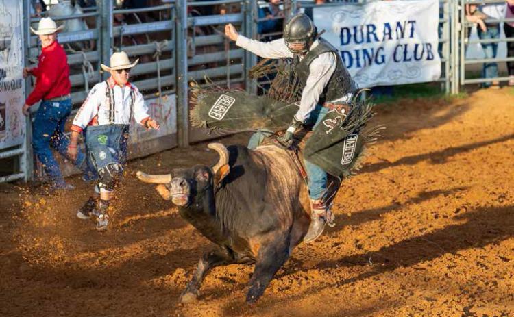 A bull rider is shown in the Durant PRCA Rodeo. LeAnn Polson |Barefoot Blonde Photographer