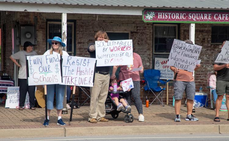 Matt Swearengin | Durant Democrat Protesters stand on the sidewalk in front of Market Square during a “Workers Over Billionaires” rally on Labor Day.