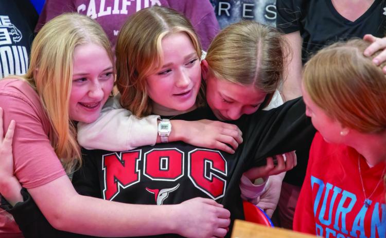 Durant wrestler Addison Polk, who signed to continue wrestling at Northern Oklahoma College, celebrates with Kenzie Trotter, Bailey Cross and Olivia Crossland.