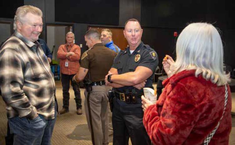 New Durant Police Chief Jesse Petty talks to Durant City Council Member Danny Sherrer and City Manager Pam Polk during a reception last week at the Donald W. Reynolds Community Center &amp; Library welcoming Petty, who began his duties as chief Thanksgiving week. Matt Swearengin | Durant Democrat