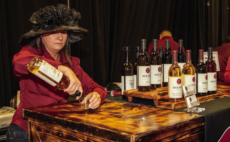 Lisa Taylor, co-owner of Rock House Vineyard, serves wine during the Leadership Durant Taste of Durant at the Choctaw Event Center. Matt Swearengin | Durant Democrat
