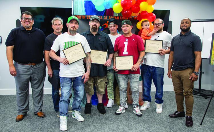 There was a recent graduation ceremony for the Fathers in Action Network. From left, Stefan Roberts, program director, Robert Ellis, Je_ery Castillo, Charles Watkins, Tyler Howell, Larry St. Laurent, Casey Wallace and Marcus Burns, program coordinator. Matt Swearengin | Durant Democrat