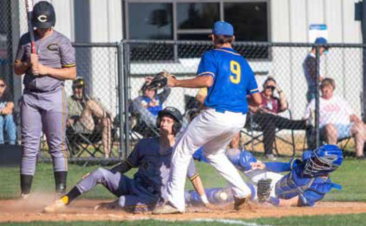 Calera Bulldog Zaiden Craige slides into home plate during last week’s home game with Rock Creek. Matt Swearengin | Durant Democrat