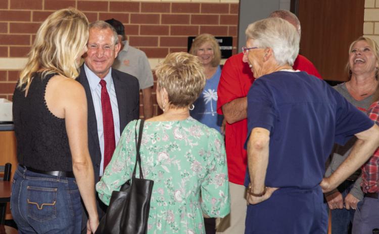 Retiring Durant Schools Superintendent Duane Merideth, left, visits with people during a recent retirement reception for him. Matt Swearengin | Durant Democrat