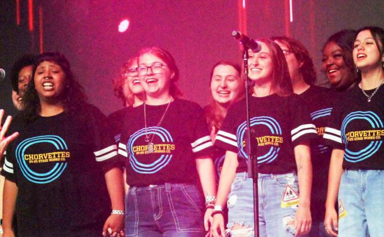 The Southeastern Oklahoma State University show choir and the Chorvettes, sing with Kelly Hansen, the lead singer of the 1980’s rock band Foreigner at the Choctaw Casino and Resort’s Grand Theater on Saturday, Oct. 13, 2024. Michael Clements | For the Democrat