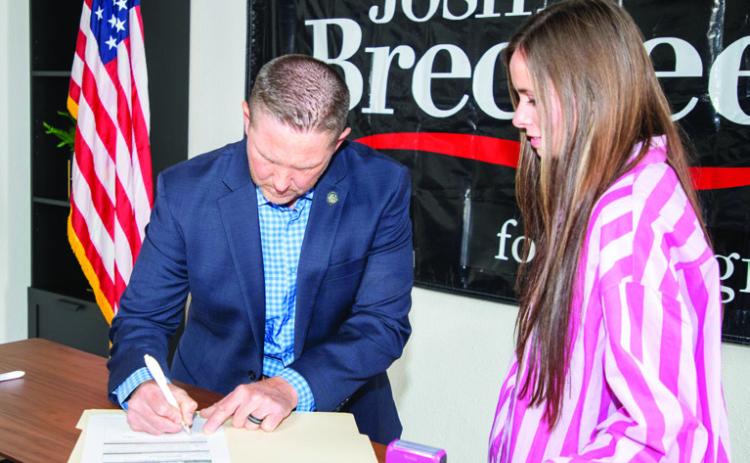 U.S. Representative Josh Brecheen signed his declaration of candidacy last week to seek reelection. He is shown with notary Brittany English. Matt Swearengin | Durant Democrat