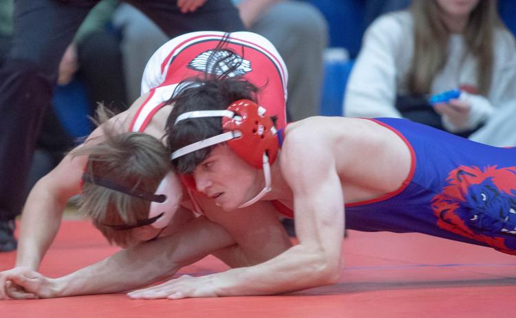 Durant Lion Kenlyn Pate wrestles with a Plainview wrestler during last week’s season opener. Matt Swearengin | Durant Democrat