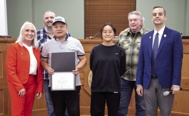 appreciation from the city during a council meeting because his restaurant donated food for 35 public works employees on Feb. 3. He is shown with his daughter Sarah Ye. Also shown are City Manager Pam Polk, council members Humphrey Miller and Danny Sherrer and Vice Mayor Mike Simulescu. Wu Ye of Asian Gourmet received a certificate of