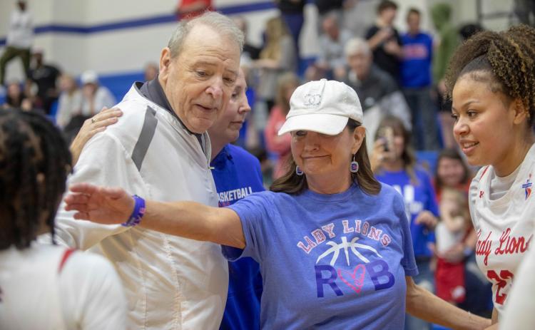 Matt Swearengin | Durant Democrat Durant girls basketball acting head coach Tony Robinson and his wife Beth react after the team secured a Class 5A regional after defeating Pryor last month. The Robinsons are the parents of head coach Will Robinson who died in a Christmas Eve car crash along with his daughter Clara.
