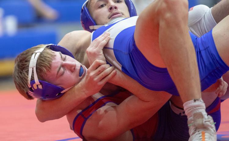 Durant Lion Aiden Polk wrestles with Little Axe wrestler Rebel Doiron during last week’s home dual. Polk won the match. Matt Swearengin | Durant Democrat