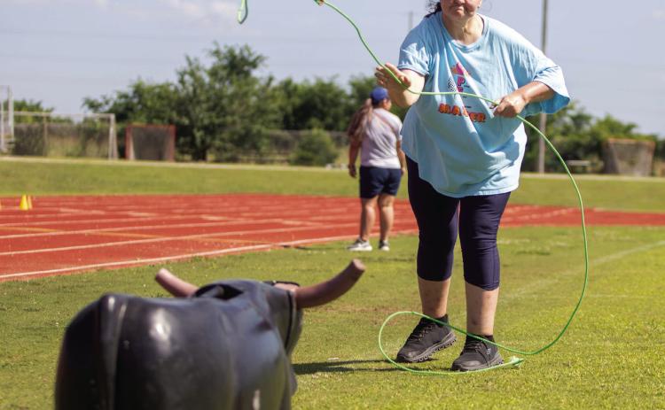 People First client Ashley Adair ropes a steer during the People First Industries Mike Morris Memorial Track &amp; Field Day. Matt Swearengin | Durant Democrat
