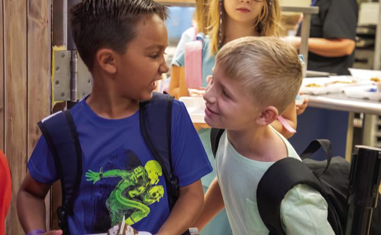 The 2024-2025 school year in Durant started Aug. 15. Getting breakfast that morning at Washington Irving Elementary School are Kolton Ford, left, and Ben Smith. Matt Swearengin | Durant Democrat