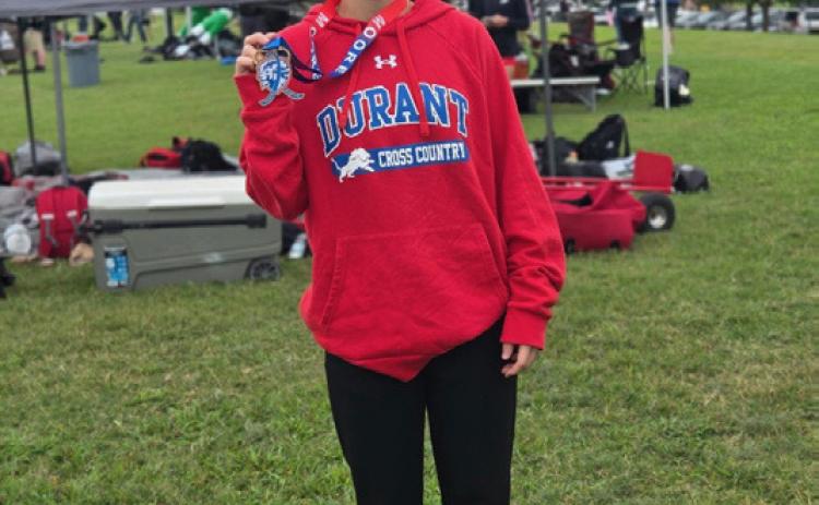 Avery Sager led the Lady Lions to a fourth place team finish as she shattered her own school record time in winning the meet individual title during the Moore Invitational on Saturday.