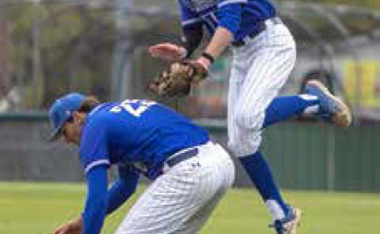 Southeastern pitcher Dylan Hill reaches for a ball that was just hit by a batter while Alex Showalter leaps in the air to try to grab it too. Matt Swearengin | Durant Democrat