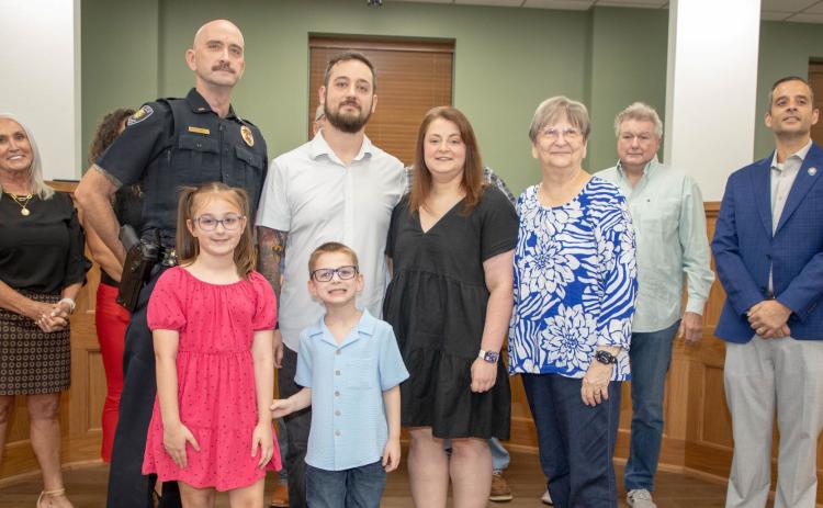 Chris Marcy has served 25 years with the Durant Police Department and he is shown with family members and city manager Pam Polk, council member Danny Sherrer and Vice Mayor Mike Simulescu. In the back but not visible are council member Lauran Fuller, Mayor Martin Tucker and council member Humphrey Miller. Not shown is Michael Stinson, who has served 30 years with the City of Durant utility line maintenance. Matt Swearengin | Durant Democrat