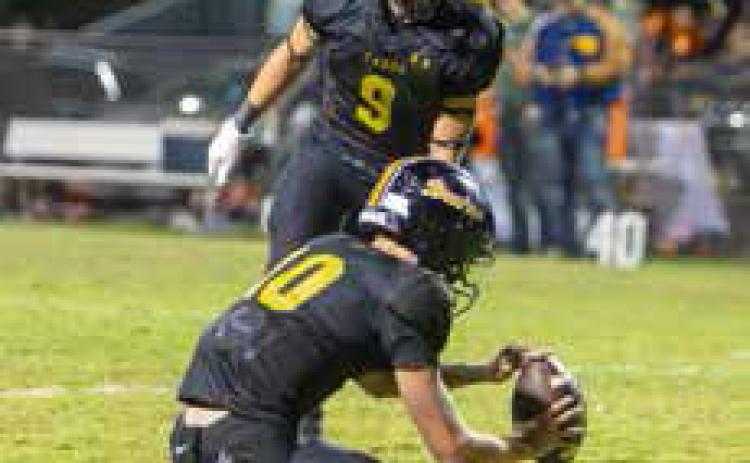 Caddo Bruin Jake McKay is about to kick the ball held by Cale Wigington during a game last season. McKay has a possibility of being quarterback. Matt Swearengin | Durant Democrat
