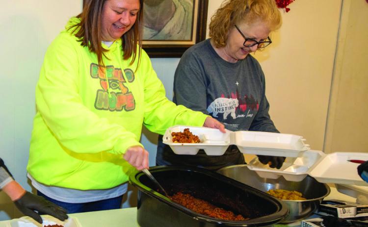 Feeding Hope Executive Director Keri Juarez serves food Feb. 13 at Grace Baptist Church and also shown is Kris Simpson, a volunteer with Durant First United Methodist Church. Normally, Feeding Hope serves at Keithley Park on Northeast Third Avenue, but when it’s cold, they serve at Grace Baptist Church. Feeding Hope said 188 meals were served that night. Matt Swearengin | Durant Democrat