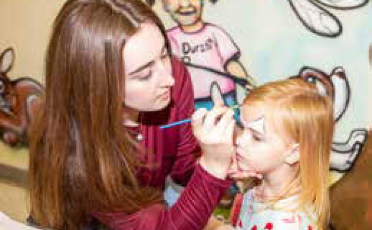 Jaxon Todd gets her face painted during the Robert E. Lee Early Childhood Center Christmas Carnival.