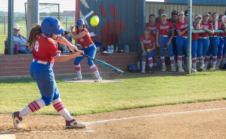 Lady Lion Ryan Uber swings at the ball in the game with McAlester while Brynn Ritenour waits on deck. Matt Swearengin | Durant Democrat