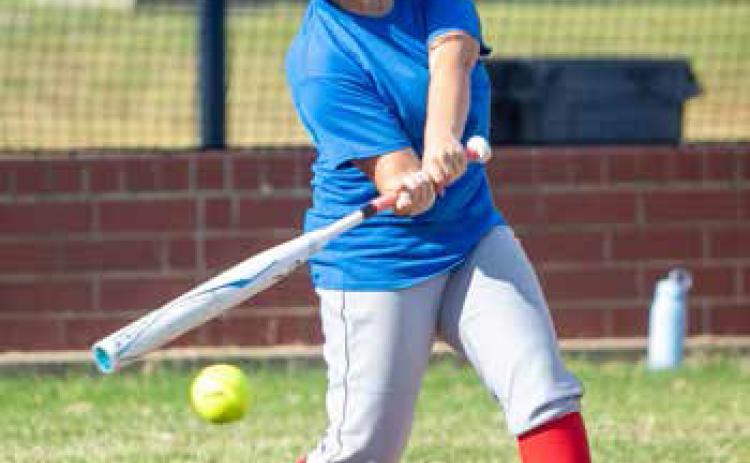Lady Lion Grace Meaders swings at the ball during a recent practice. Matt Swearengin | Durant Democrat