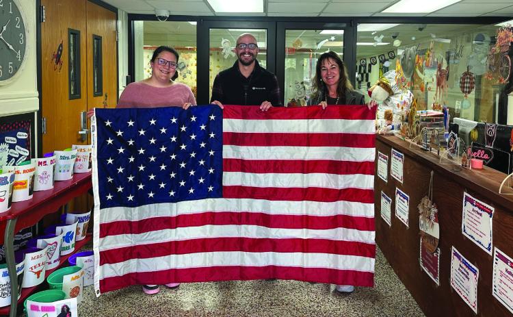 Photo provided | WI WoodmenLife recently provided Washington Irving Elementary School with an American and Oklahoma flag. Pictured are (left to right) Maegan Morgan, WI principal, WoodmenLife representative, Hudson Toews, and WI assistant principal, Liz Dunn. WI students, teachers and sta would like to say a big “thank you” to WoodmenLife for providing our school with the American and state flag so we may fly them proudly at our school.