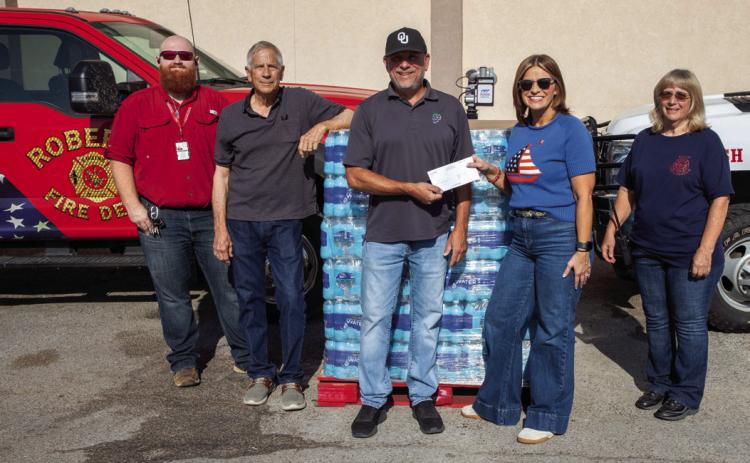 Pallets of bottled water were provided to area fire departments after First United Bank partnered with other entities to collect donations. Shown from left at Pruett’s Food are, Cody Allen, Bryan County Emergency Management director; Keith Falcone, Mike Ritter, store manager; Melissa Patterson of First United Bank, and Sarah Morgan, Kemp Fire Department. Matt Swearengin | Durant Democrat