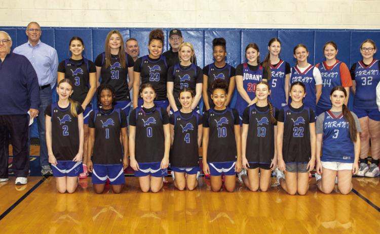 The Durant Athletic Booster Club and the Will and Clara Robinson memorial scholarships received funds after Butch Arnett, winner of a ra_e during a pep rally last fall, decided to give the money back. The funds were presented during a practice of the Durant Lady Lions basketball team. Matt Swearengin | Durant Democrat
