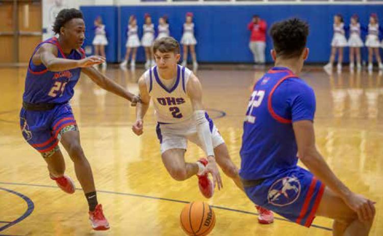 Lion Ryder Jones moves down court flanked by Tulsa Memorial players during a recent home game. Matt Swearengin | Durant Democrat