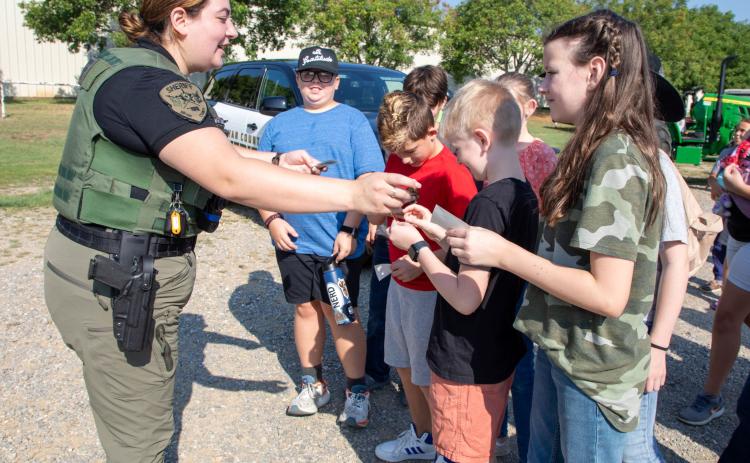 Bryan County Sheriff’s Deputy Madelynn Castanon passed out stickers at school day during the Bryan County Free Fair. Matt Swearengin | Durant Democrat
