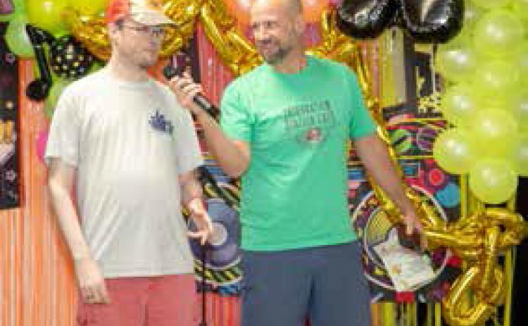 festival Aug. 10 at the Clay Jones Community Center. Shown are PFI client Jordan and Jeremy Spence, PFI board member. People First Industries had its annual arts and music