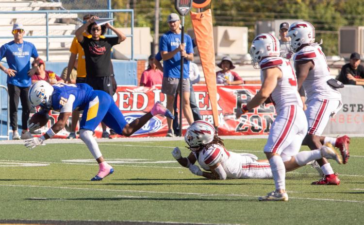 Savage Storm player Johnathon Cobb stumbles with the ball during the game with Southern Nazarene at Paul Laird Field. Matt Swearengin | Durant Democrat