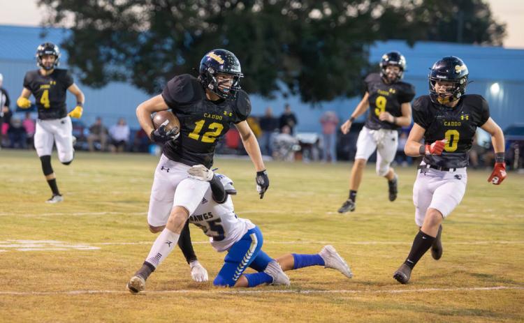 A Savanna player attempts a tackle on Caddo Bruin Jake Mullens. Also shown are Bruins Jake McKay and Boen Proctor. Matt Swearengin | Durant Democrat