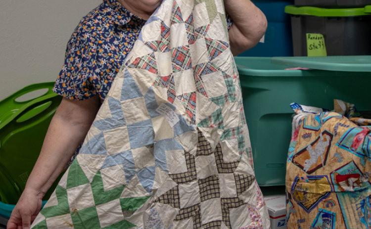 Toni Stiefer shows a quilt made by her late sister, Dr. Rebecca Kilpatrick Davis, that will be sold to benefit J127 Ministry. Matt Swearengin | Durant Democrat