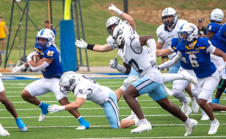 Savage Storm football players Kobe Jennings. DJ Brown, Gabe Corona and Dameon Smallwood are among those shown in last Saturday’s game with Southwestern. Matt Swearengin | Durant Democrat