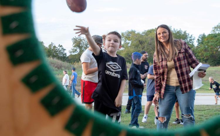 A boy throws a football during the George Washington Elementary School Fall Fest.