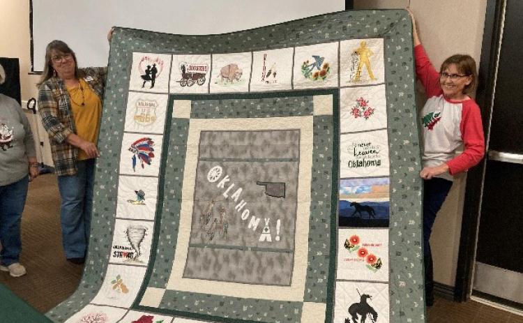 The winner of the OHCE Quilt Raffle was Jana Crawford. She is on the right with her Oklahoma-themed queen size quilt with Donna Collins, OHCE Quilt co-chair. Photo provided