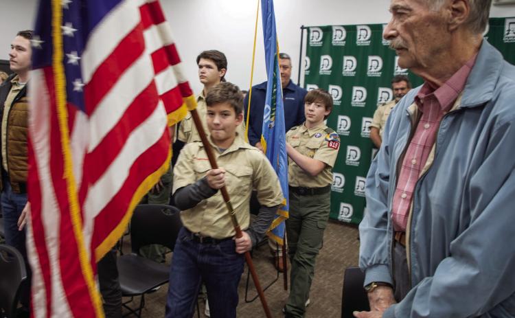 Jim Harmon watches as Durant Boy Scouts present the colors during a recent Durant City Council meeting. Matt Swearengin | Durant Democrat