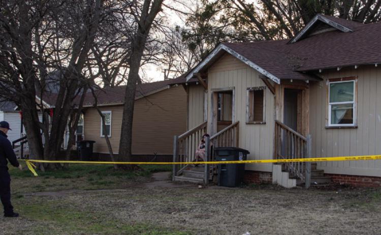 Police tape is placed around a home at 206 W. Elm St. where a woman was injured during a stabbing. Matt Swearengin | Durant Democrat