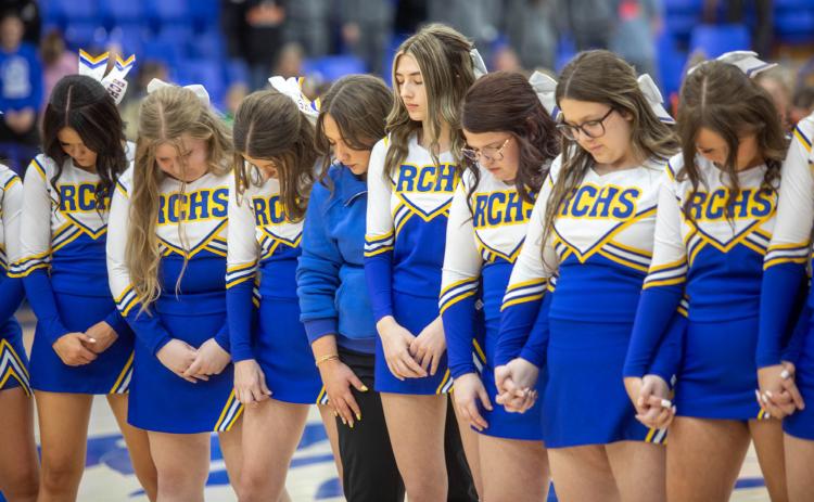 Rock Creek High School cheerleaders bow their heads in prayer before the homecoming basketball game Feb. 5 with Valliant. Matt Swearengin | Durant Democrat
