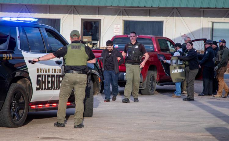 Zachary Aaron Holderness is taken into custody by sheriff’s deputies following a standoff in the parking lot of EZ Mart on North First Avenue. Matt Swearengin | Durant Democrat