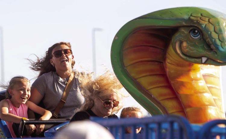 The 26th Magnolia Festival was May 30-June 1 at Choctaw Event Center and Mitchell’s Amusement Carnival was presented by Cardinal FG. Shown on one of the rides are Jessica Williams and her daughters Presley Beck and Harper Williams. Matt Swearengin | Durant Democrat