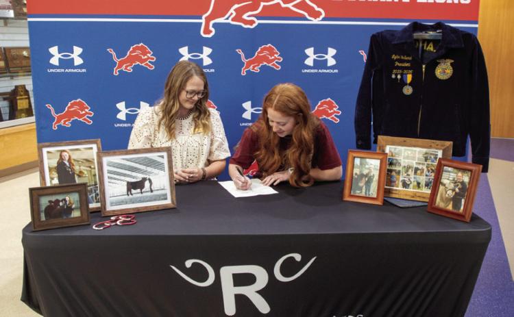 Durant High School senior Lydia Bullard signed last week with the beef show team at Redlands Community College in El Reno. She is shown with Merideth Behrens, beef team coach at Redlands. Matt Swearengin | Durant Democrat