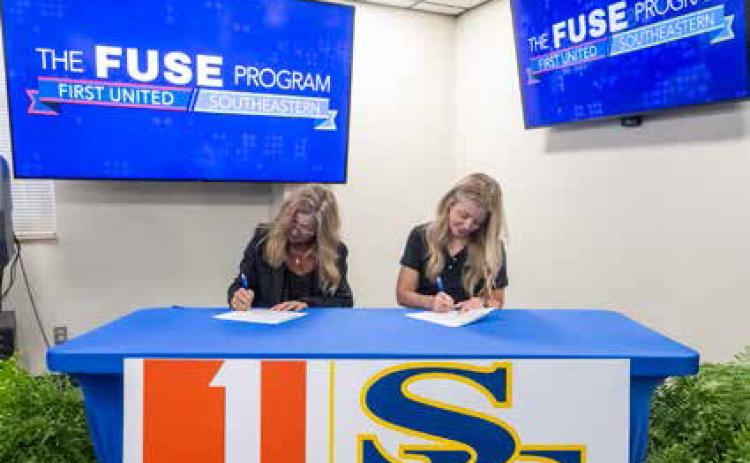 Dr. Rhonda Richards, left, dean of the John Massey School of Business, and Melissa Perrin, executive vice president and chief culture and communication officer of First United Bank, sign a partnership that will connect students with professional experience and career opportunities in banking and corporate operations. Dan Hoke | SE