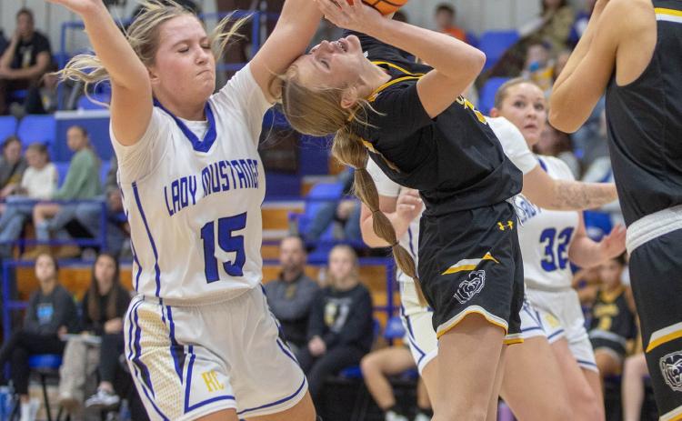 Matt Swearengin | Durant Democrat Rock Creek Lady Mustang Macey Weger blocks a shot by Caddo Lady Bruin Braylee Malone.