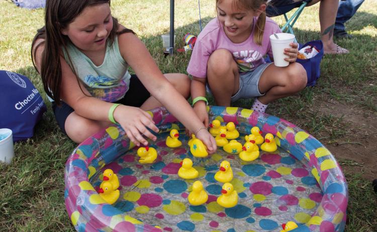 Matt Swearengin | Durant Democrat Paislee Sigl, left, 10, and Blaiklee Sigle, 8, play with rubber duckies during the Fathers in Action End of Summer Bash on Saturday at Youth Services of Bryan County.