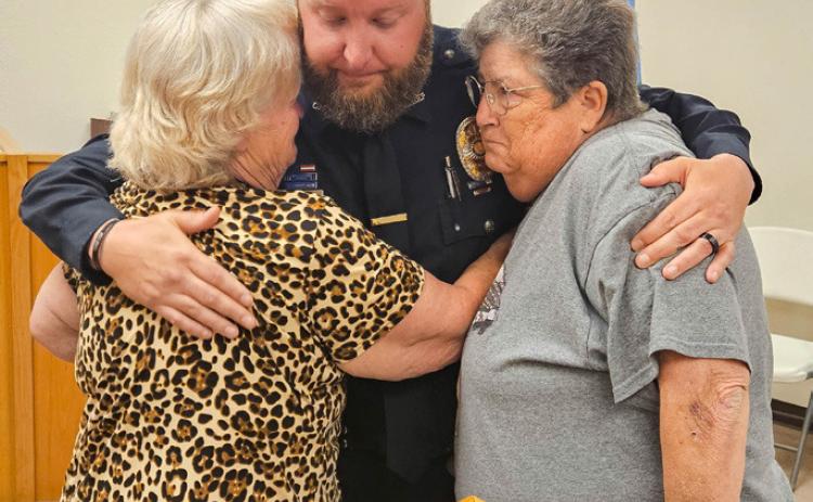 Kasey Cox is embraced after the Kingston Council voted to terminate him as police chief during a meeting last week. Matt Swearengin | Durant Democrat