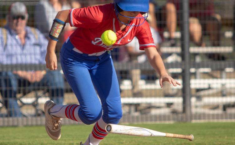 Lady Lion Anslee Morse drops the bat after hitting the ball. Matt Swearengin | Durant Democrat